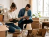 Young siblings creating a photographic inventory of inherited furniture and personal belongings in a Budapest apartment